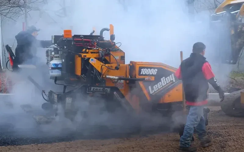 Paving contractors in Connecticut laying down hot mix asphalt on a commercial parking lot in New Haven County 